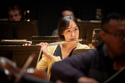 Hyejin Bae plays flute during a rehearsal of the University Symphony Orchestra at von der Mehden Recital Hall on Nov. 16, 2015. (Peter Morenus/UConn Photo)